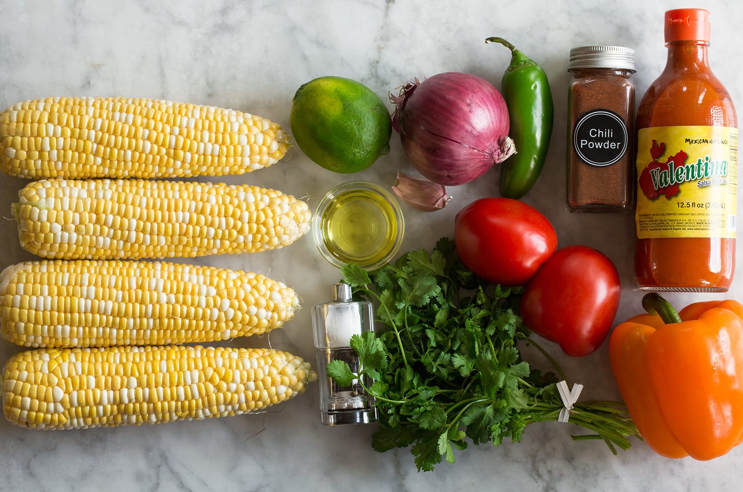 Ingredients needed to make corn salsa shown.