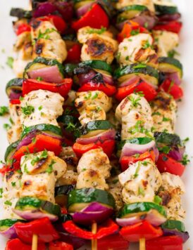 Greek Chicken Kebabs on skewers with marinated chicken breast, zucchini, bell pepper and red onion.