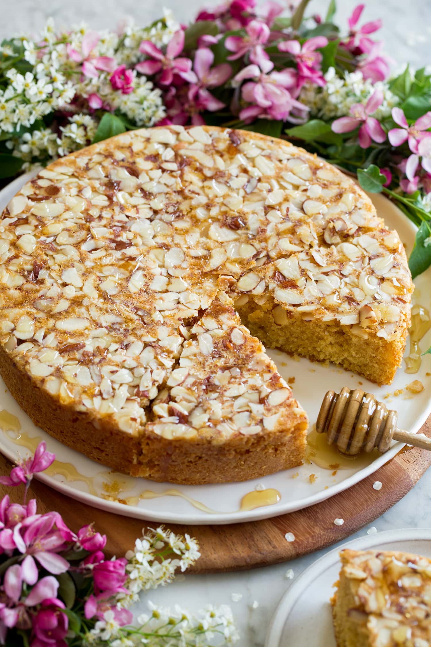 Whole honey cake on a platter cut into slices.