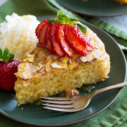 Honey cake shown with variation of serving with strawberries and ice cream.