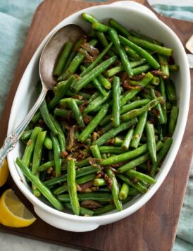 Sauteed fresh green beans shown in a white serving dish.