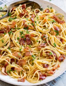 Pasta carbonara shown in a large white serving bowl.