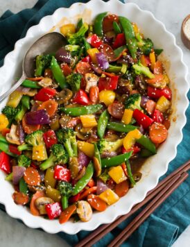 Rainbow stir fried vegetables with sauce in a serving dish.